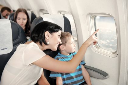 Child Sitting on Airplane Looking Out Window – Commercial Photography Portfolio