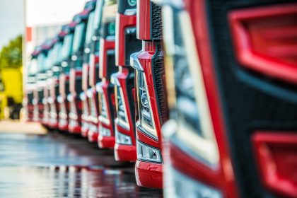 Rows of Red Cars in a Factory Setting – Car Advertising Image