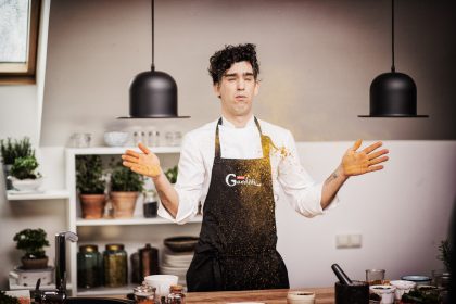 Man in Formal Attire Standing Near Shelves – Professional Event Reportage