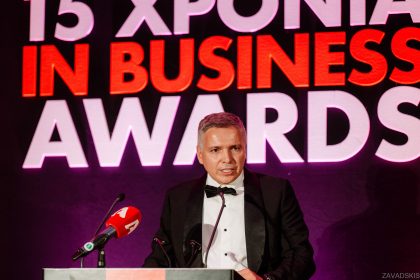 Man in Suit Speaking at Event – Business Event Image