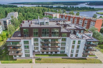 Modern Building with Garden and Surrounding Area – Real Estate Exterior Image