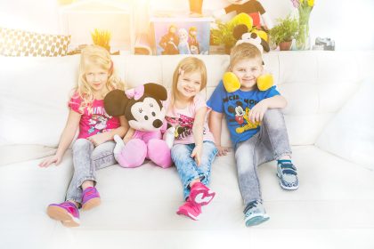 Two Children Sitting on a Sofa, Playful and Natural – Child Lifestyle Portrait