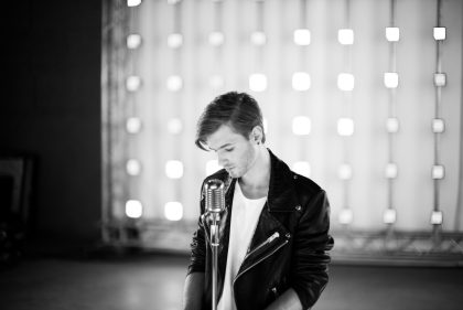 Musician on Stage, Wearing a Black Jacket – Concert Photography Portfolio